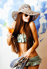 Image showing cute bright woman in sunglasses and hat with cocktail in bikini in studio close up