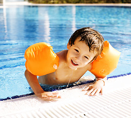 Image showing little cute boy in swimming pool wearing handcarves