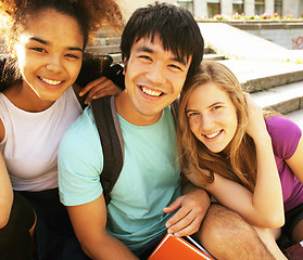 Image showing cute group of teenages at the building of university with books huggings, back to school