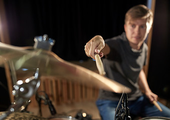 Image showing male musician playing drums and cymbals at concert