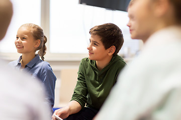 Image showing group of happy kids or friends learning at school