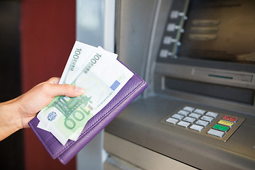 Image showing close up of hand withdrawing money at atm machine