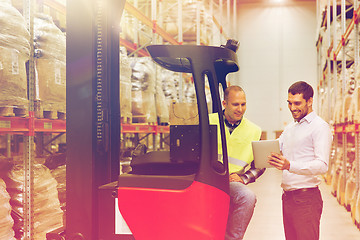 Image showing men with tablet pc and forklift at warehouse