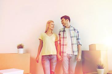 Image showing smiling couple with big boxes moving to new home