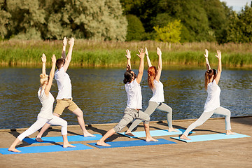 Image showing group of people making yoga exercises outdoors