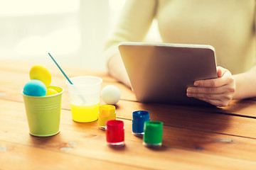 Image showing close up of woman with tablet pc and easter eggs