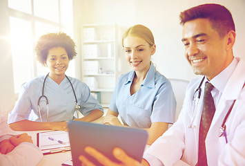 Image showing happy doctors with tablet pc meeting at hospital