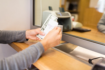 Image showing customer with money and receipt at bank counter