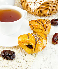 Image showing Cookies with dates and tea in cup on board