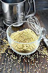 Image showing Flour hemp in glass cup with mixer on board