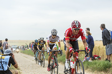 Image showing Group of Cyclists Riding on a Cobblestone Road - Tour de France 