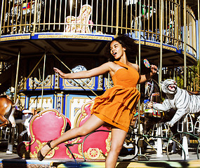 Image showing teenage with candy near carousels