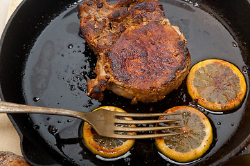 Image showing pork chop seared on iron skillet