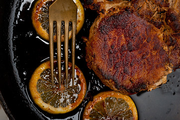 Image showing pork chop seared on iron skillet