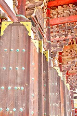 Image showing Large wooden doors with golden decorations