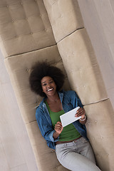 Image showing african american woman at home with digital tablet top view