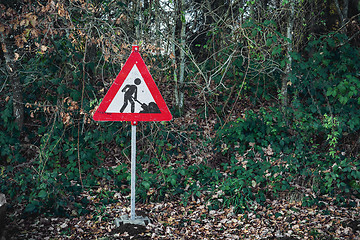 Image showing Under construction sign with a digging worker