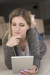 Image showing young women used tablet computer on the floor