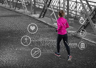 Image showing Woman running across the bridge