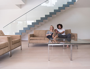 Image showing Young couple on the sofa watching television