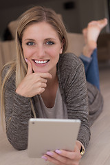 Image showing young women used tablet computer on the floor