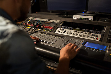 Image showing man using mixing console in music recording studio