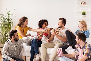 Image showing happy friends with popcorn and beer at home