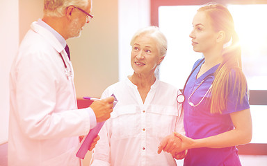 Image showing medics and senior patient woman at hospital