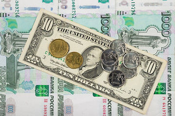 Image showing Coins ruble and the euro are on the bill of ten dollars which lies on a pile of thousand-Russian banknotes