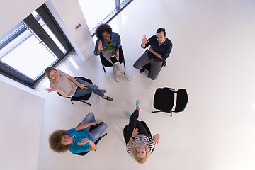 Image showing Multiethnic startup business team on meeting  top view