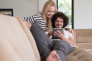 Image showing couple relaxing at  home with tablet computers