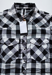 Image showing close up of checkered shirt on white background