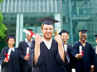 Image showing happy student with diploma celebrating graduation