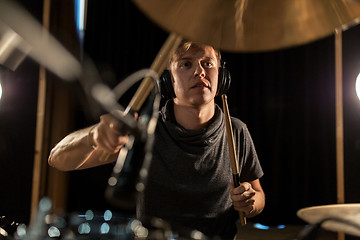 Image showing male musician playing drums and cymbals at concert