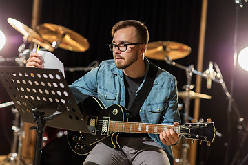 Image showing man playing guitar at studio rehearsal