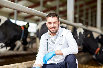 Image showing veterinarian and cows in cowshed on dairy farm