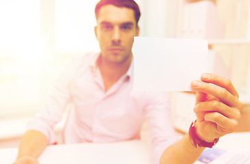 Image showing close up of businessman with blank paper at office