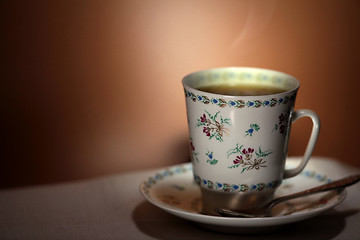 Image showing  cup with hot tea and steam on background