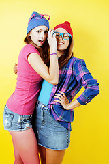 Image showing lifestyle people concept: two pretty stylish modern hipster teen girl having fun together, happy smiling making selfie