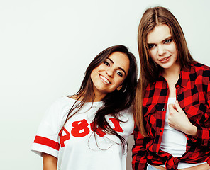 Image showing best friends teenage girls together having fun, posing emotional on white background, besties happy smiling, lifestyle people concept, blond and brunette multi nations 