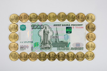 Image showing Russian thousandth banknote is imposed on a ten coins perimeter