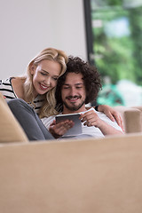 Image showing couple relaxing at  home with tablet computers