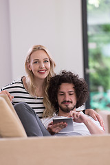 Image showing couple relaxing at  home with tablet computers