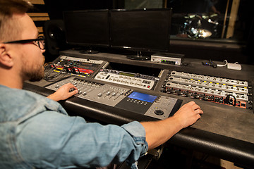 Image showing man at mixing console in music recording studio