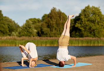 Image showing couple making yoga outdoors