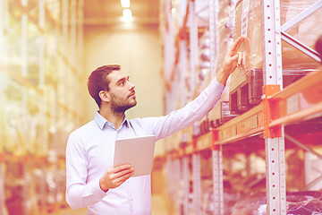 Image showing businessman with tablet pc at warehouse