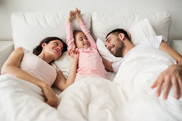 Image showing happy family waking up in bed at home