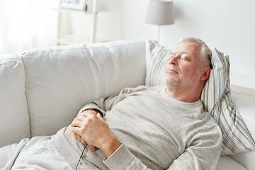 Image showing senior man sleeping on sofa at home