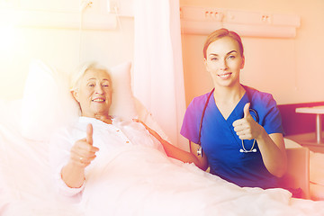 Image showing nurse and senior woman showing thumbs up at clinic