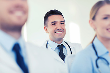 Image showing happy doctor over group of medics at hospital